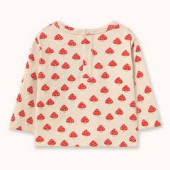 A long-sleeve baby top in cream-colored ribbed fabric by designer Tiny Cottons, featuring an all-over red and white mushroom print. The top has a three-button placket at the collar and is photographed flat against a light off-white background.