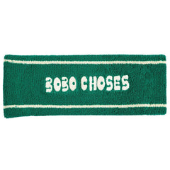 Bobo Choses Green Terry Headband by Bobo Choses, green terry cloth headband with white stripes and Bobo Choses logo.
