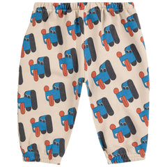 The Doggy Mate All Over Jogging Pants from Bobo Choses with blue and black doggy pattern on a beige background.
