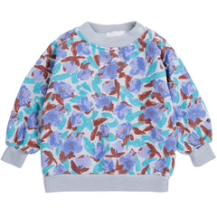 The Watercolor All Over Sweatshirt from Bobo Choses in fleece with a periwinkle floral print and blue ribbed cuffs.