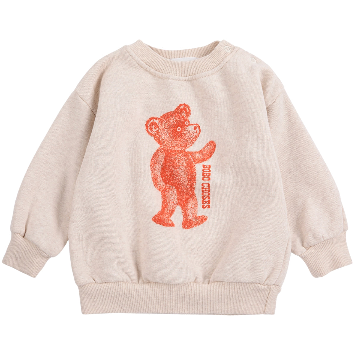 The Softpaw Monster Sweatshirt from Bobo Choses in heathered oatmeal with an orange teddy bear graphic and shoulder snaps.