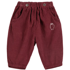 The Curious Owl Corduroy Pants from Bobo Choses in burgundy with an elastic waist, front buttons, and embroidered owl.