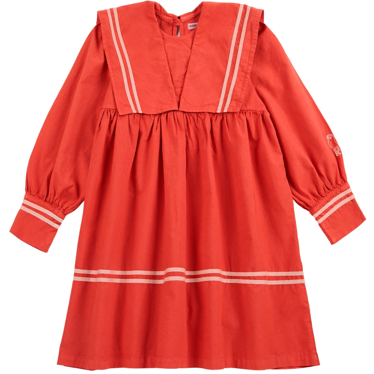 The Bobo Choses Sailor Dress in coral red cotton featuring a sailor collar, double stripe details, and long cuff sleeves.