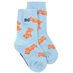 The Softpaw Monster All Over Short Socks from Bobo Choses in light blue knit with an orange teddy bear print and BC logo.