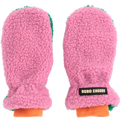 The Color Block Sheepskin Mittens from Bobo Choses in pink and green plush fleece with orange ribbed cuffs and a logo patch.