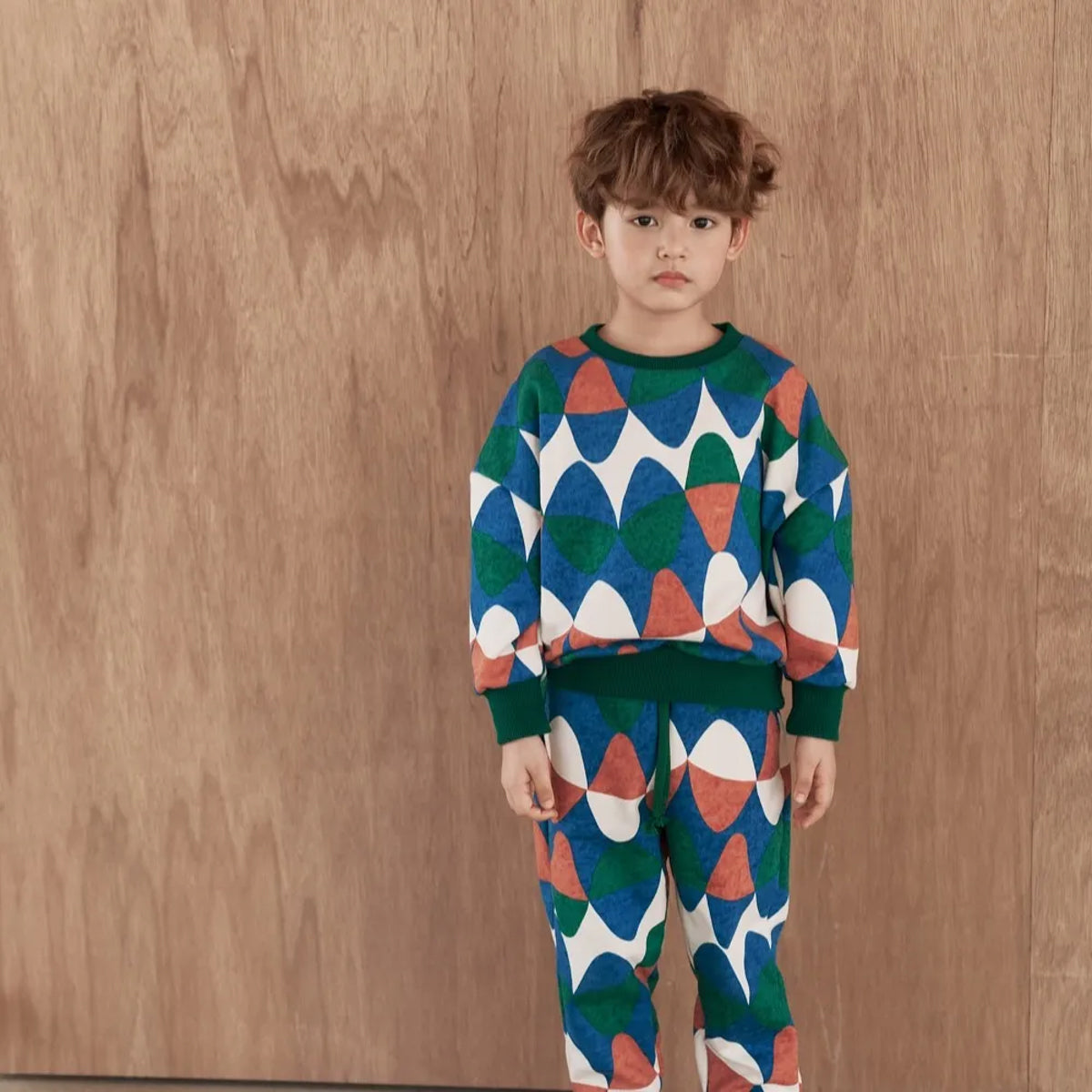 Momohanipopo Bubble SW Top with colorful geometric bubble print, green ribbed cuffs, and crew neckline.