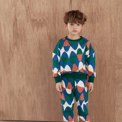 Momohanipopo Bubble SW Top with colorful geometric bubble print, green ribbed cuffs, and crew neckline.