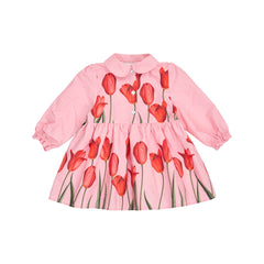 The long-sleeve Pink Tulip Baby Dress from Christina Rohde with a pink base and a large red tulip print, featuring a Peter Pan collar, puff sleeves, button front, and gathered waist seam.