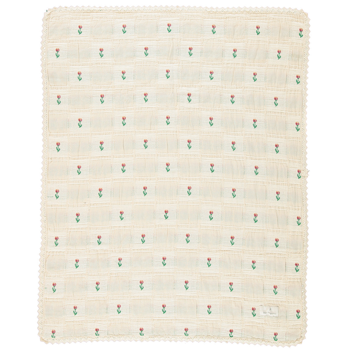 The Bella Blanket from Bebe Organic featuring a floral patchwork jacquard pattern and signature lace edging.