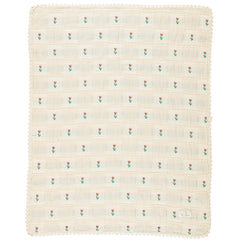 The Bella Blanket from Bebe Organic featuring a floral patchwork jacquard pattern and signature lace edging.