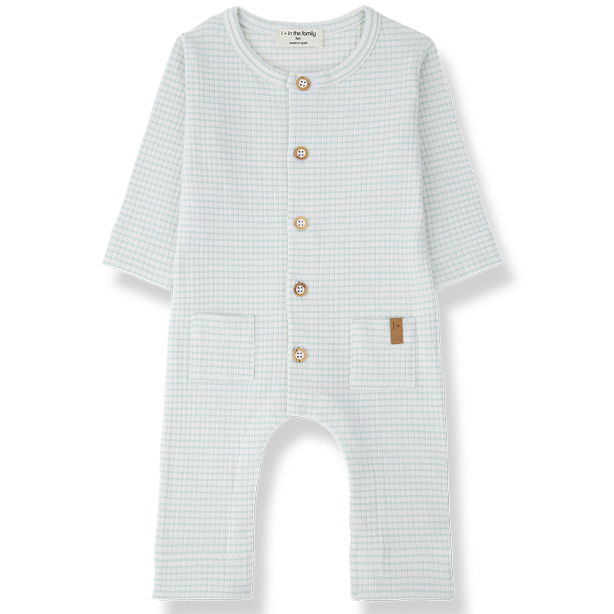 The Cambrils Jumpsuit from 1+ in the Family, a soft baby one-piece with a check pattern, front buttons, and two small front pockets.