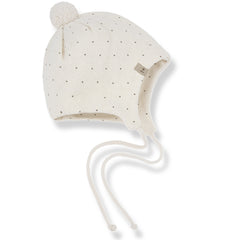 The Carlota Beanie from 1+ in the Family. Soft knit baby bonnet with subtle dotted pattern, pom-pom detail, and tie strings.