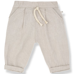 The Castell Pants from 1+ in the Family in beige with elastic waistband, braided drawstring, front pockets, and rolled cuffs.