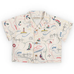 Clove Baby Shirt from The New Society with nautical print, short sleeves, button front and collar, cream background