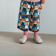 Momohanipopo Check Pants featuring a bold geometric check pattern in blue, mustard, and cream with a wide-leg fit.