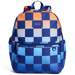 State Bags Kane Backpack with blue, orange, and white checkerboard print, front zip pocket, and logo patch