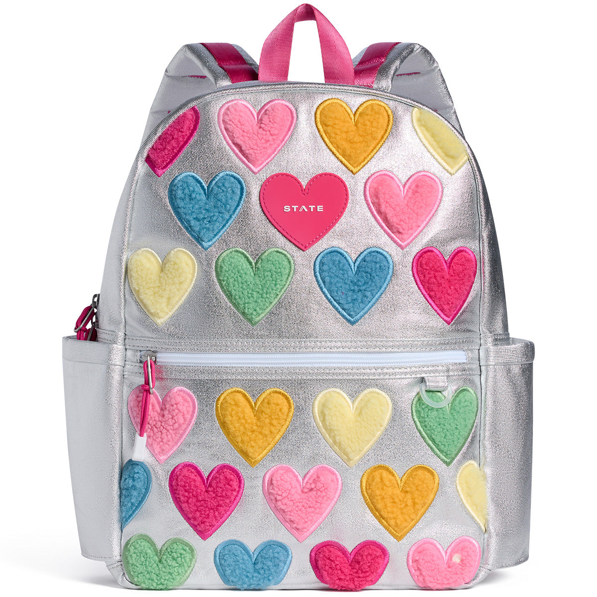 State Bags Kane Backpack in silver with colorful fuzzy heart patches, front zip pocket, and pink top handles