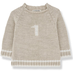 The Didac Sweater from 1+ in the Family. A cozy beige knit with a subtle "1" detail, ribbed cuffs, and hem.