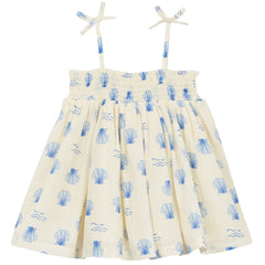 The Baby Shell Dress from Arsene et Les Pipelettes. Exclusive seashell print baby dress. Smocked at the chest.