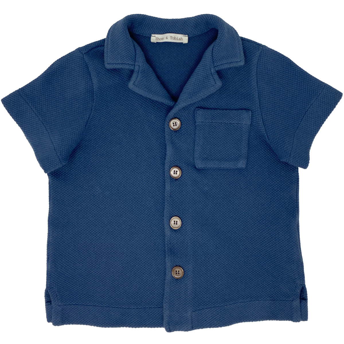 Indigo Knitted Shirt from Zhoe & Tobiah. This short-sleeve blue shirt features a textured knit fabric, button-down front.