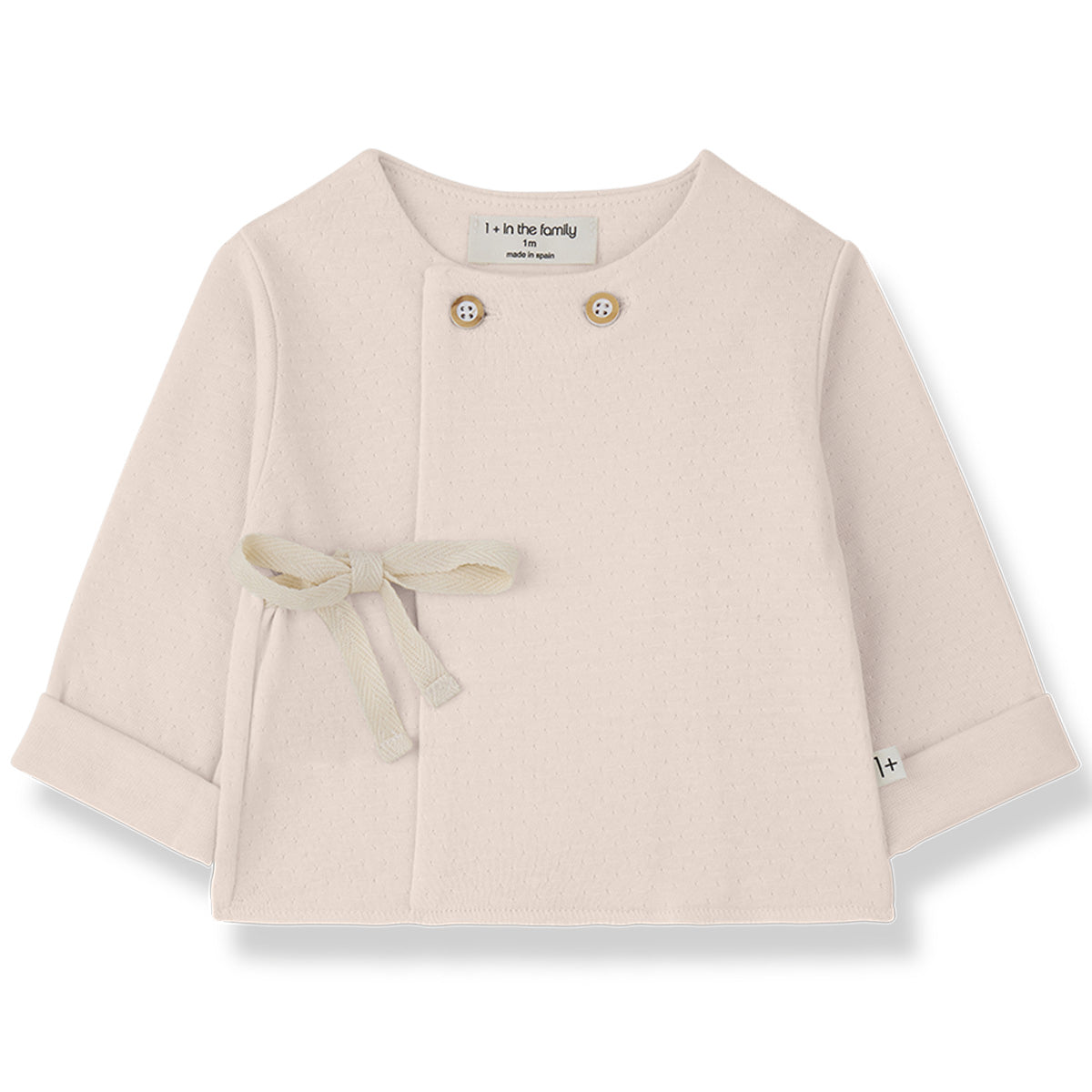 The Emilia Shirt from 1+ in the Family, a soft baby top with shoulder buttons, wrap front, and side tie detail.