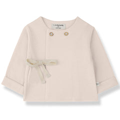 The Emilia Shirt from 1+ in the Family, a soft baby top with shoulder buttons, wrap front, and side tie detail.