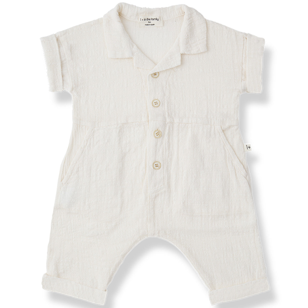 The Fonteta Overall from 1+ in the Family in off-white with collar, front buttons, rolled sleeves, and side pockets.