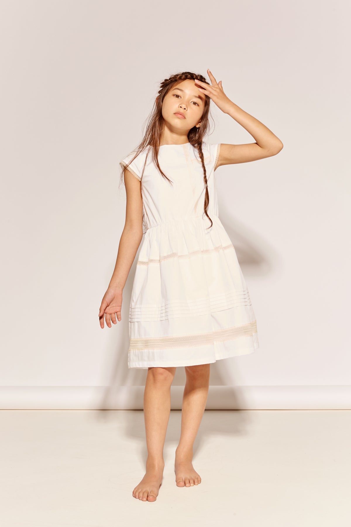 The Four O'clock Dress by The Middle Daughter in white cotton with lace trim and gathered skirt details.