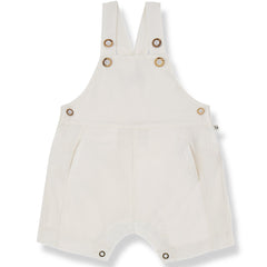 The Galfi Short Dungaree from 1+ in the Family in off-white with button straps, side buttons, and snap closures.