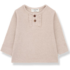 The Greta Tee from 1+ in the Family. Ribbed knit long-sleeve top in soft nude pink with a ruffle trim and front buttons.