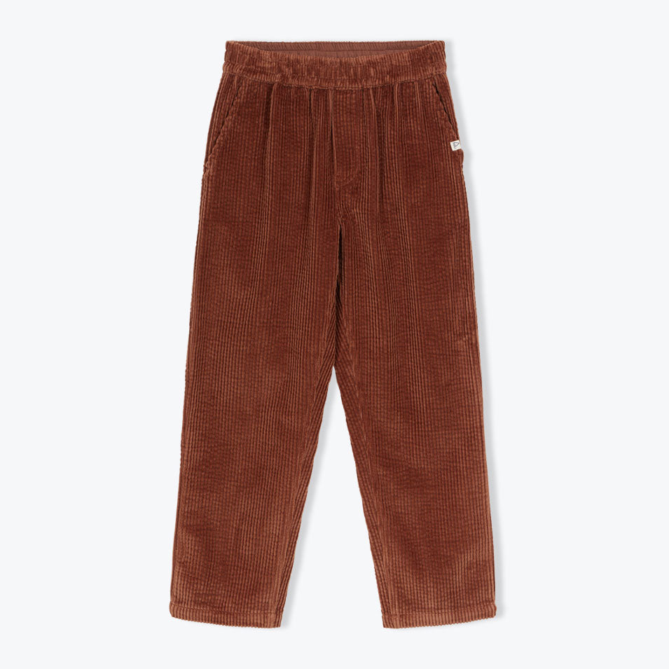 The Velvet Pants from Arsene et Les Pipelettes are GOTS-certified organic cotton corduroy pants with a regular fit, elasticated waistband, internal drawstring, side slit pockets, and back patch pockets with an AP badge.