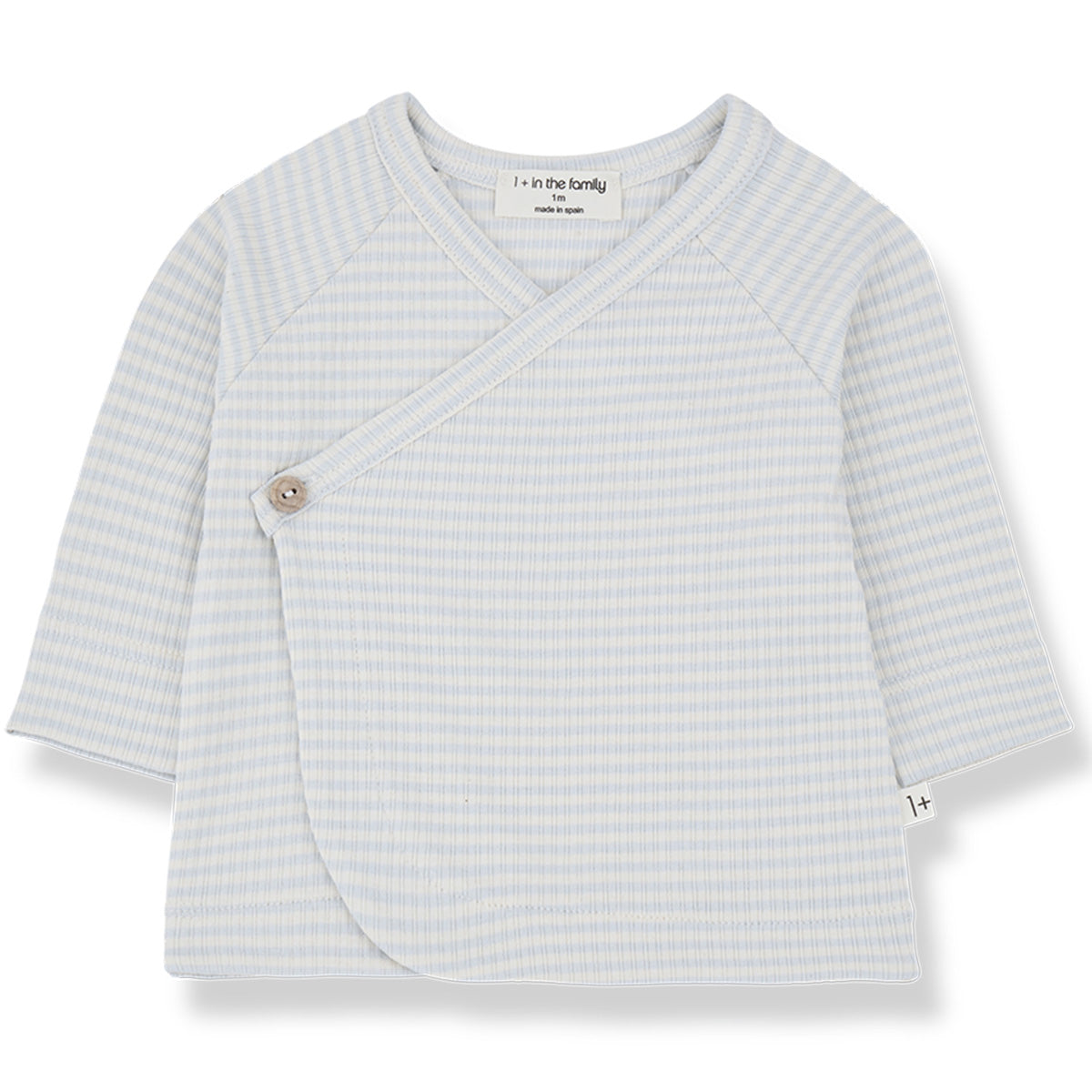 The Idara Shirt from 1+ in the Family. A charming baby wrap top featuring a crossover front with a button closure.