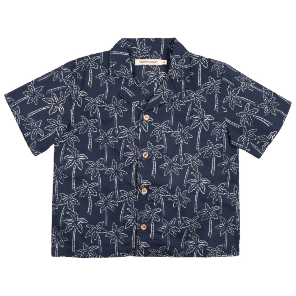 Ithaki Shirt from The New Society. A short-sleeved button-up shirt with a navy base and an all-over white palm tree print.