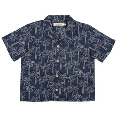 Ithaki Shirt from The New Society. A short-sleeved button-up shirt with a navy base and an all-over white palm tree print.