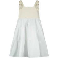 is a sleeveless dress featuring a textured cream bodice with tie straps and a soft tiered white skirt for a light, airy silhouette.