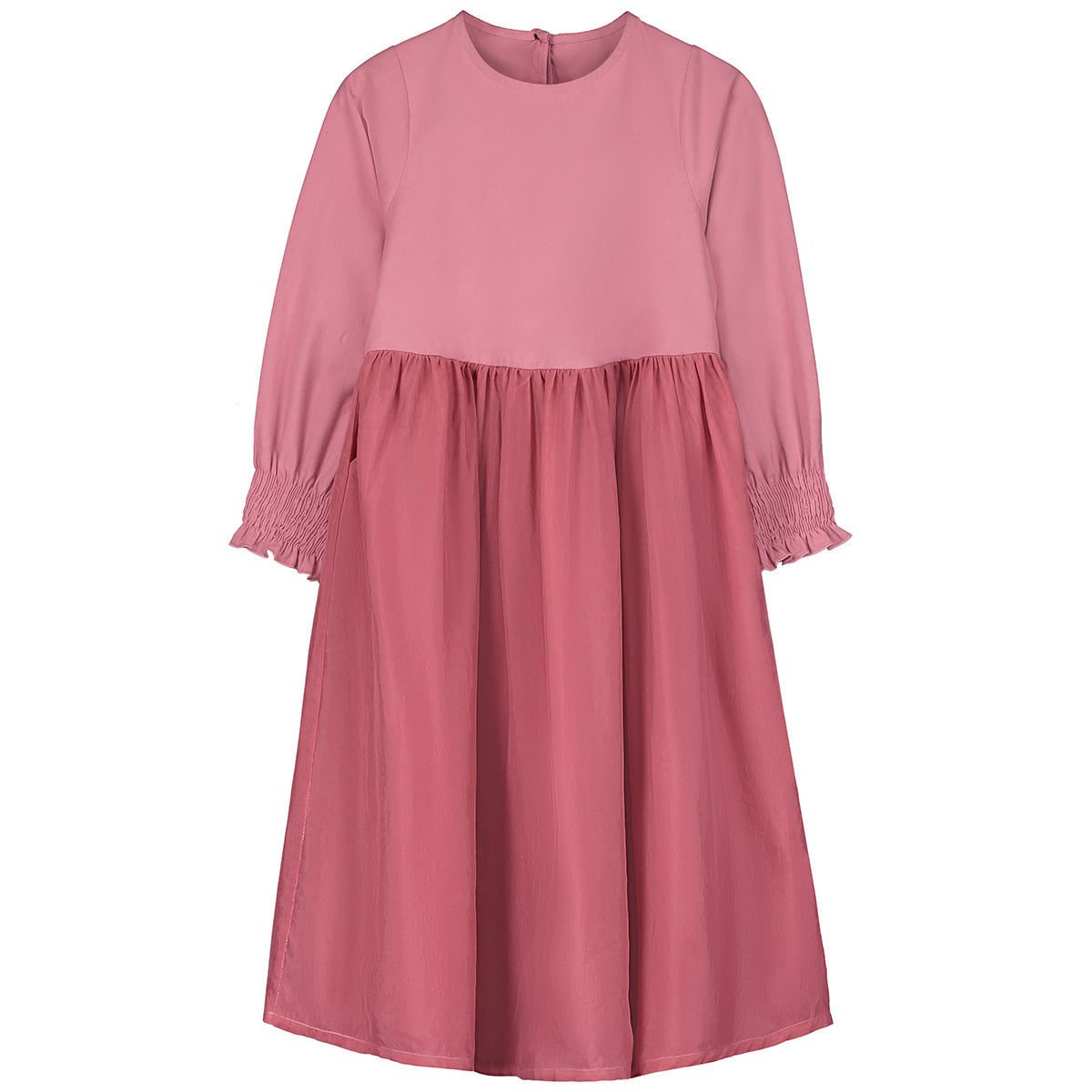 The Forest Dress from Little Creative Factory. A pink dress featuring long sleeves with smocked cuffs.