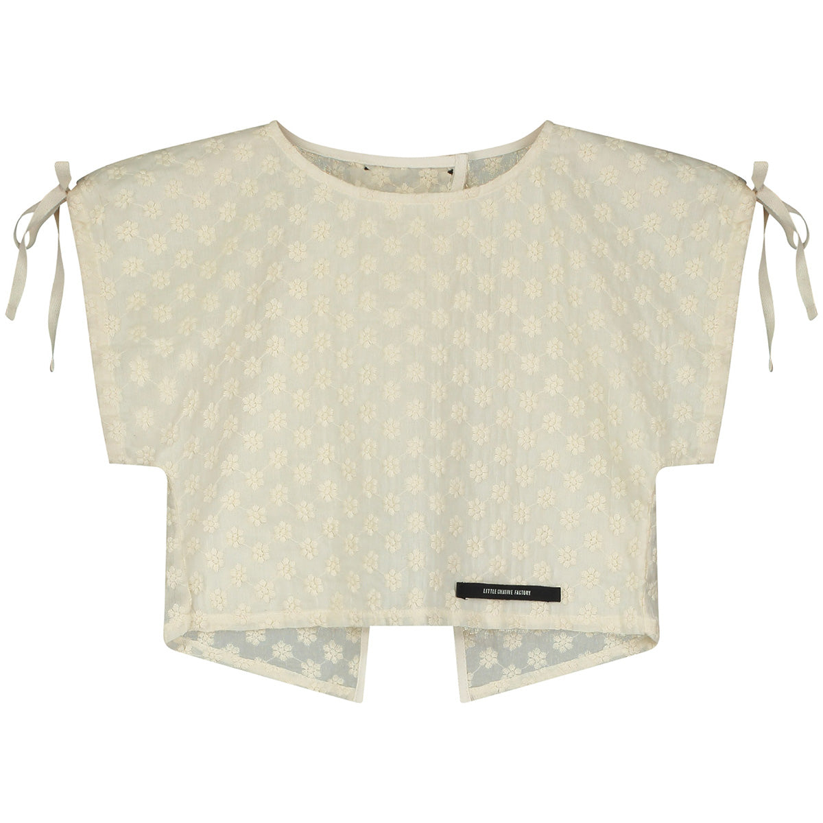 The Spring Top from Little Creative Factory in cream with floral embroidery, shoulder ties, and a lightweight cropped silhouette.