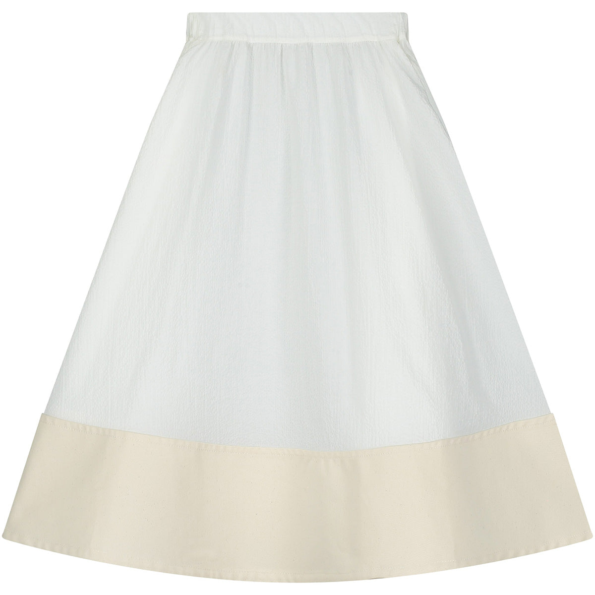 The Cruise Skirt from Little Creative Factory in white with gathered waist and contrast cream hem.