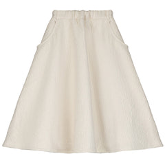 The Dune Circle Skirt from Little Creative Factory. This cream-colored skirt has a flared silhouette with side pockets.