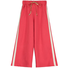The Red Sweatpants from Little Creative Factory. Vibrant red straight leg pants with single cream stripe on each side.