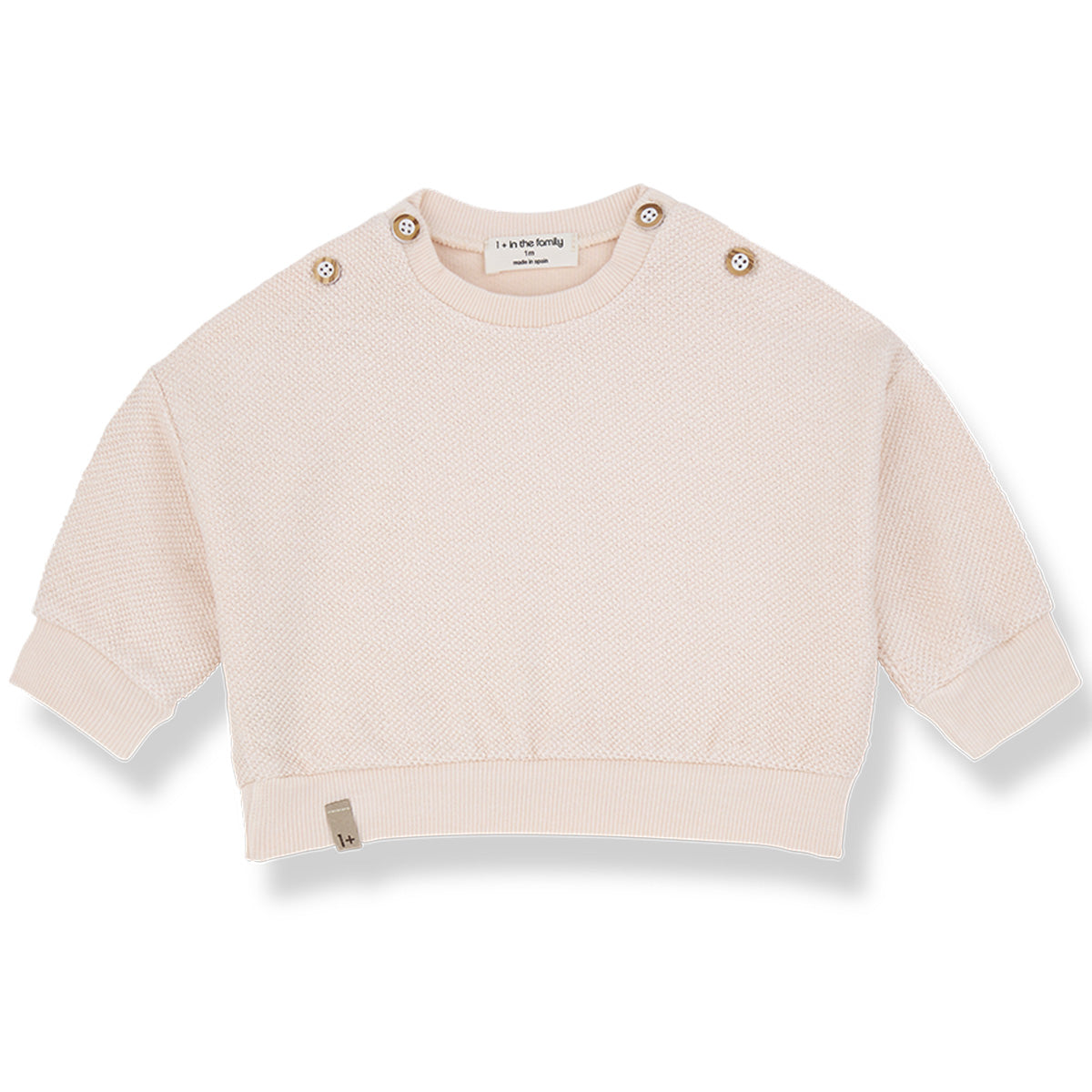 The Kimolos Sweater from 1+ in the Family, a textured baby sweater with shoulder buttons, ribbed cuffs, and hem.