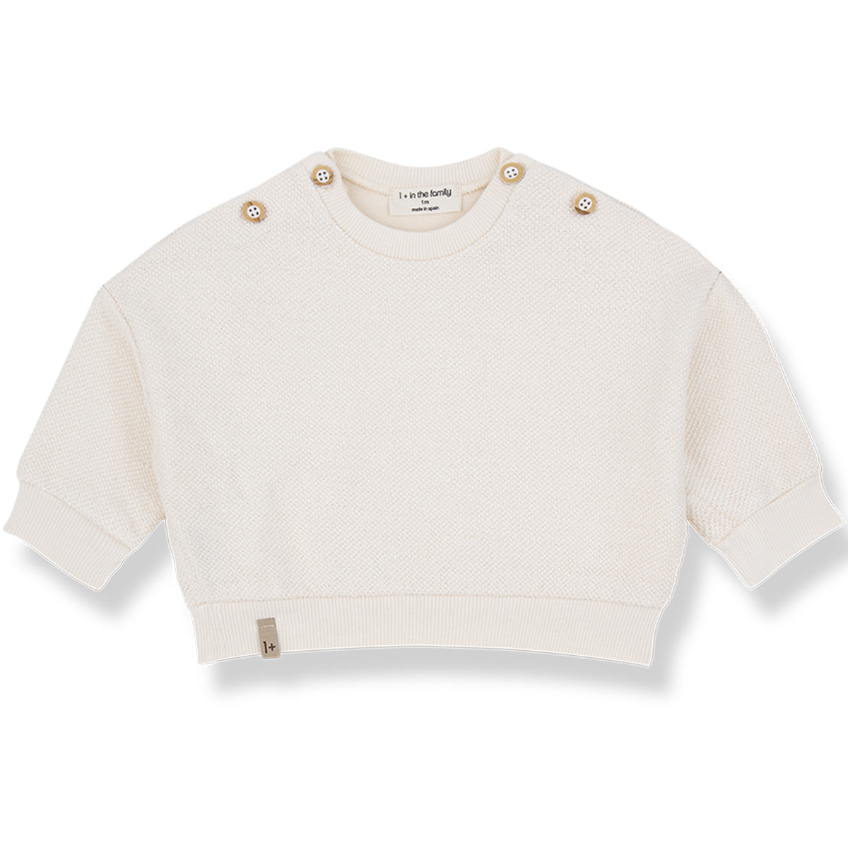The Kimolos Sweater from 1+ in the Family, a textured baby sweater with shoulder buttons, ribbed cuffs, and hem.