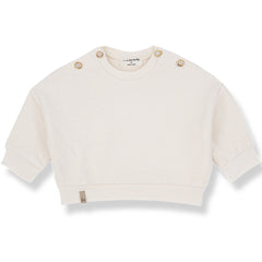 The Kimolos Sweater from 1+ in the Family, a textured baby sweater with shoulder buttons, ribbed cuffs, and hem.