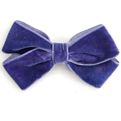 The Knot Pin from Hello Simone featuring a velvet bow with a hair pin for easy styling.