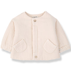 The Lemnos Padded Jacket from 1+ in the Family, a quilted baby jacket with a round neck, front buttons, and two patch pockets.
