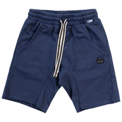 The Patch Mikey Short from Munster. Dark denim-colored shorts with a comfortable elastic waistband and contrast drawstring.