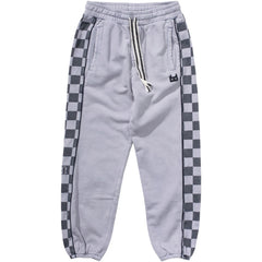 The Player Pant from Munster. Light grey kids’ joggers with checkered side panels, elastic waist with drawstring.