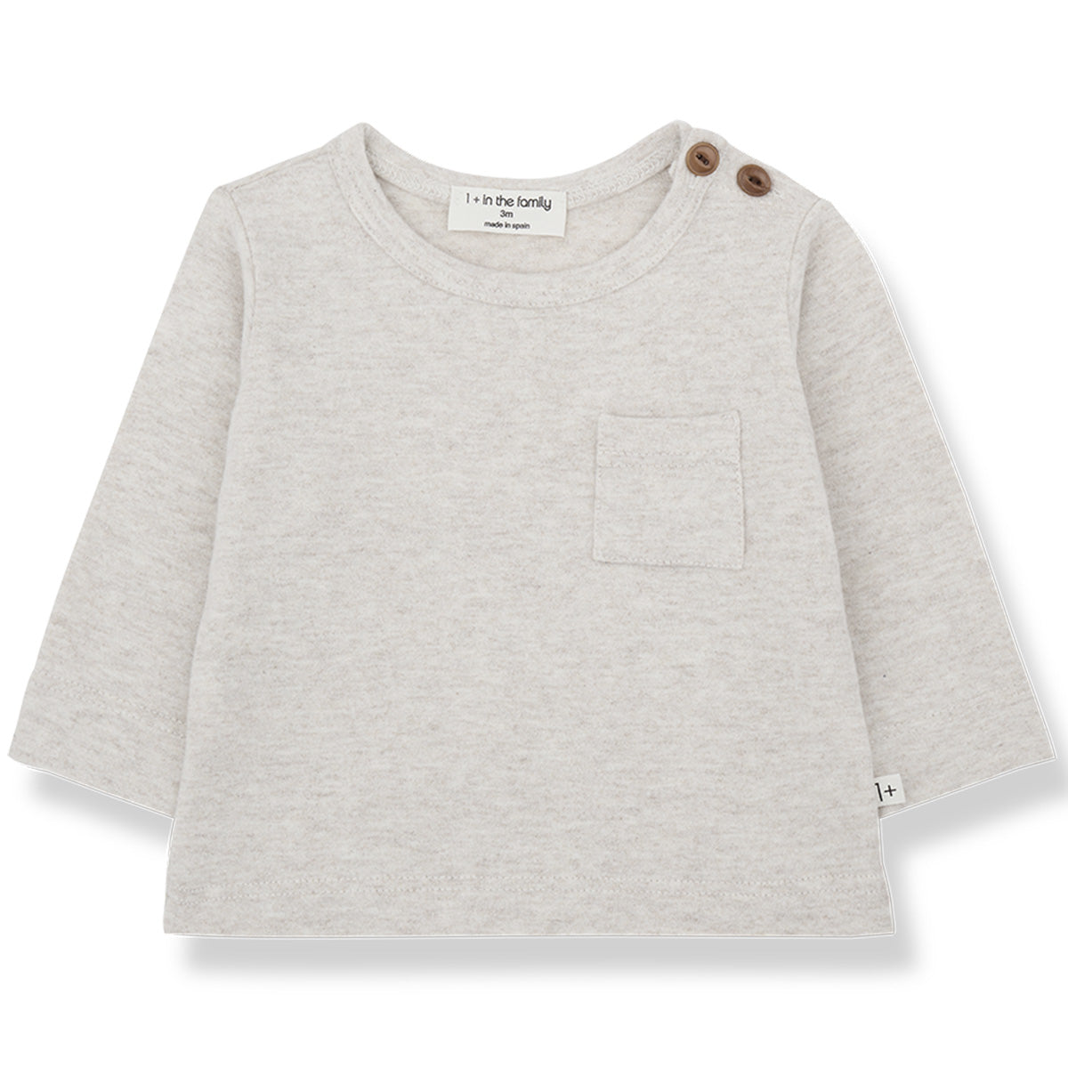 The Oriol Tee from 1+ in the Family. Long-sleeve baby top with a chest pocket and two shoulder buttons.
