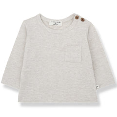 The Oriol Tee from 1+ in the Family. Long-sleeve baby top with a chest pocket and two shoulder buttons.