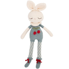 The Britney Bunny Cherry Blossom Doll from Patti Oslo. Knitted toy rabbit with gray overalls and red shoes on a white background.